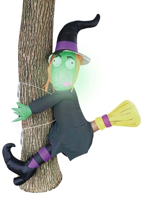 Halloween decorations witch crasxing into tree